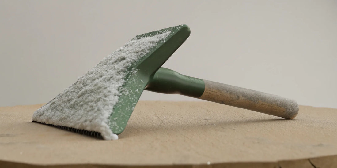 Heavy duty ice scraper for fleet vehicles clearing a windshield.