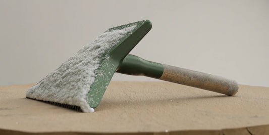 Heavy duty ice scraper for fleet vehicles clearing a windshield.
