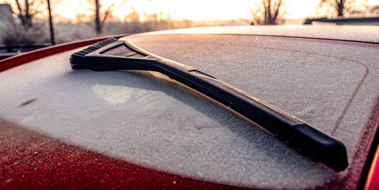 A heavy-duty ice scraper clearing thick ice from a car window.
