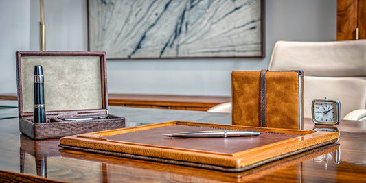 A branded pen and notebook on an executive desk, a low cost per impression gift for law firm brand awareness.