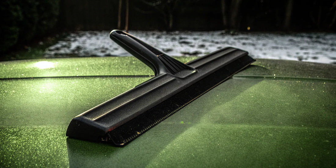 A branded snow scraper clearing a windshield, a smart promotional item for businesses to buy in bulk.