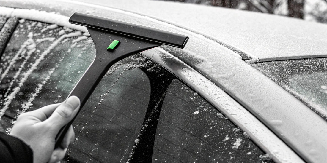Bulk vehicle-safe snow scraper clearing a fleet vehicle's window for improved winter safety.