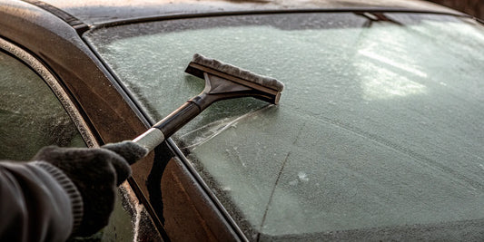 Heavy duty ice scraper clearing ice from a vehicle windshield