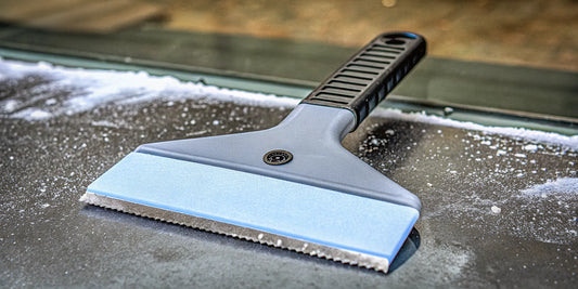 How a customized ice scraper with a logo clears frost from a car windshield.