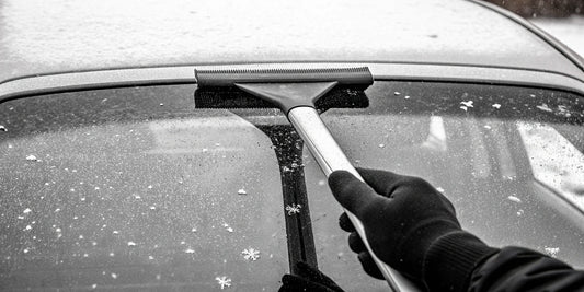 A non-scratch ice scraper clearing ice from a car's windshield.