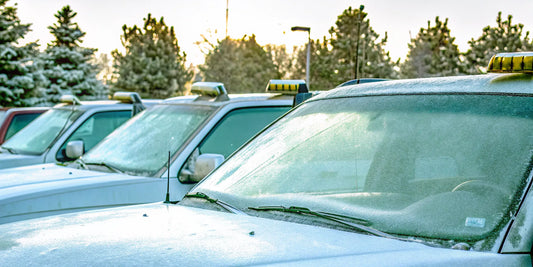 A fleet of commercial vehicles with frosted windshields needing a bulk order of heavy duty ice scrapers.