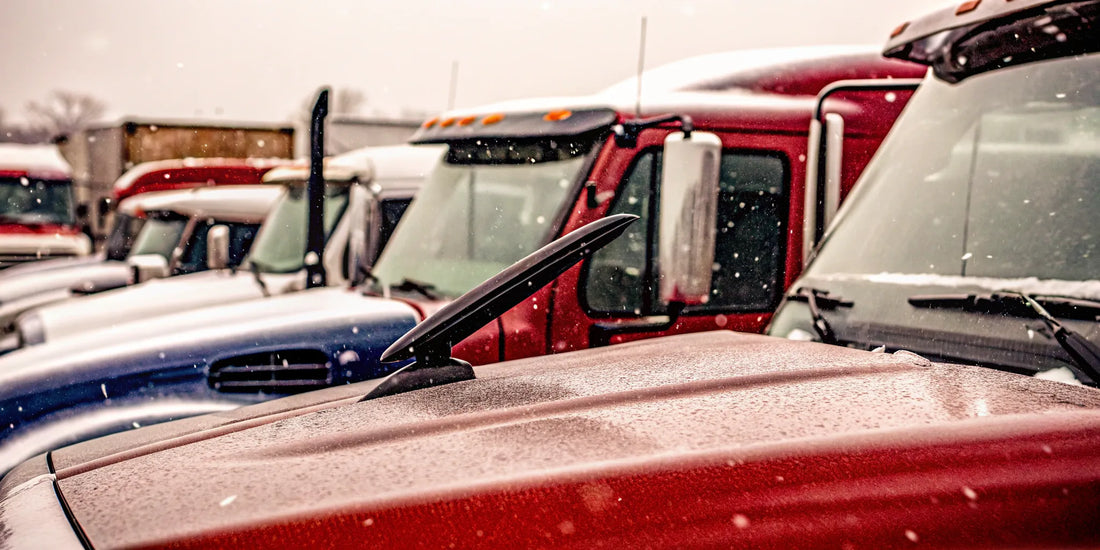 A fleet of snow-covered trucks shows why managers buy bulk snow scrapers.