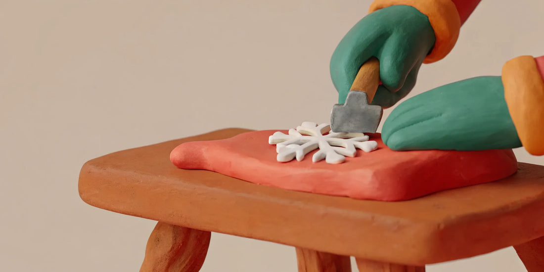 A clay figure scrapes a snowflake, part of learning how to maintain a car ice scraper.