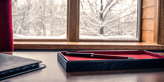 Premium branded ice scraper resting with legal documents on a wooden office desk