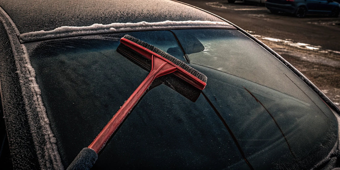 Promotional products snow scraper beside a frosted vehicle