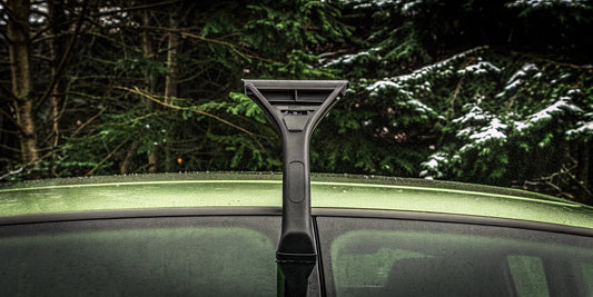 The Edge multi-function scraper quickly clears ice and snow from a car windshield.