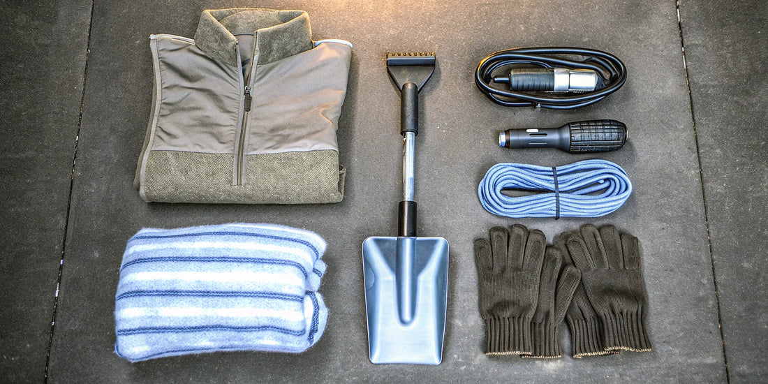 A complete winter vehicle emergency kit with tools like a shovel and jumper cables for roadside safety.
