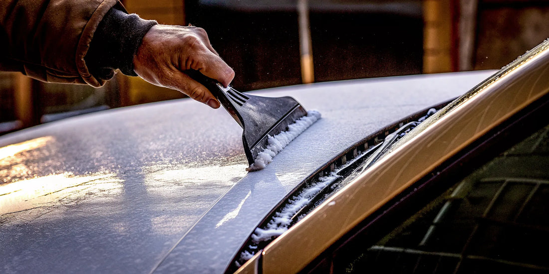A rubber ice scraper safely clearing thick ice from a car's windshield.