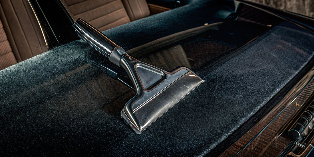A waterproof mitt ice scraper clearing thick ice from a car windshield.