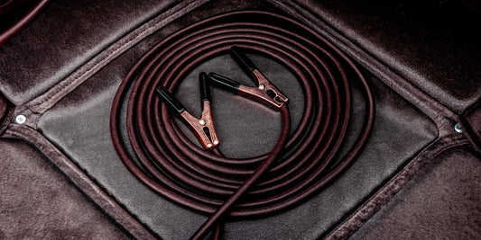 A set of jumper cables for a winter car care emergency kit.