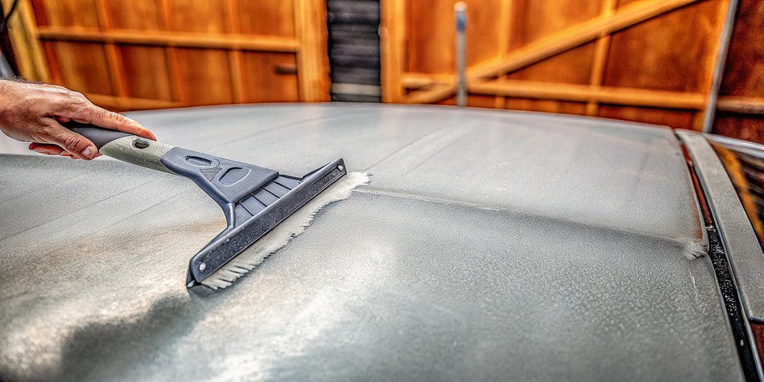 A paint-safe ice scraper clearing ice from a car, a quality performance backed by a strong warranty.