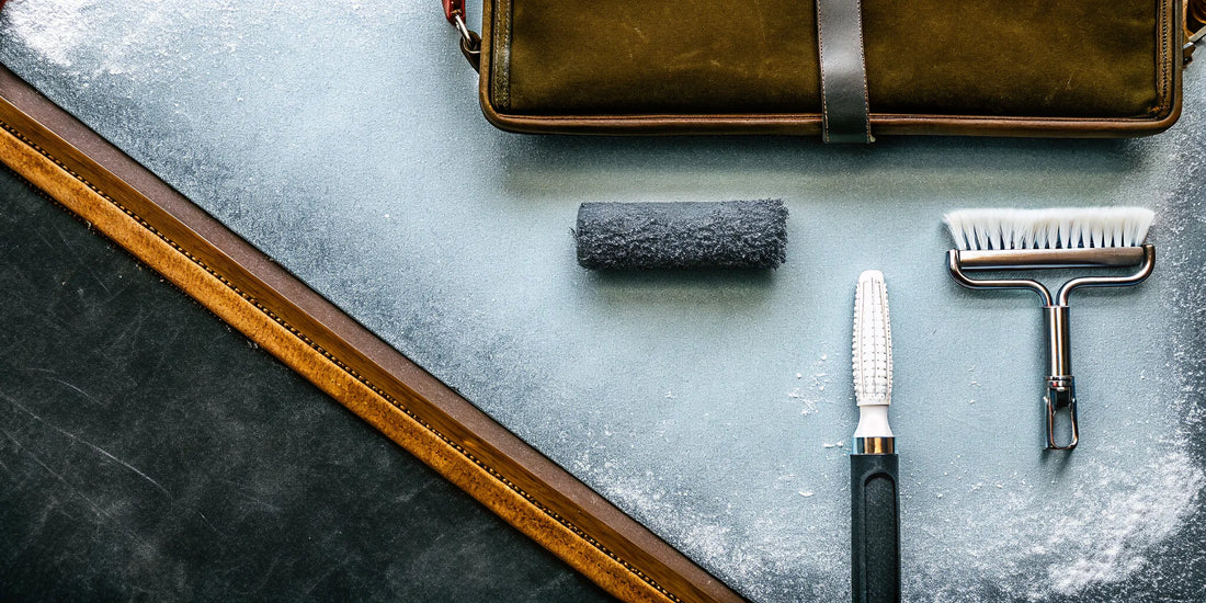 Essential winter auto accessories like a snow brush and ice scraper on a frosty surface.