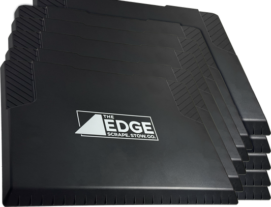 Stack of black car mats with 'The Edge' logo on a white background