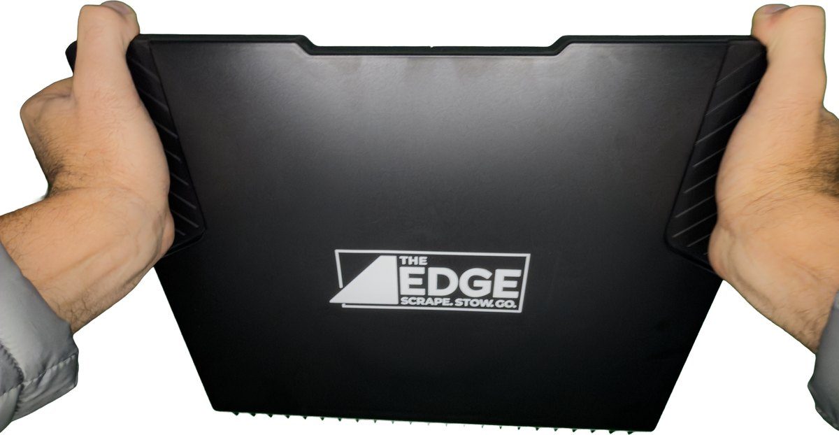 Passenger Window Ice Clearing Grip: logo facing the camera, palms on the two leverage pads at the upper corners, bull nose edge down