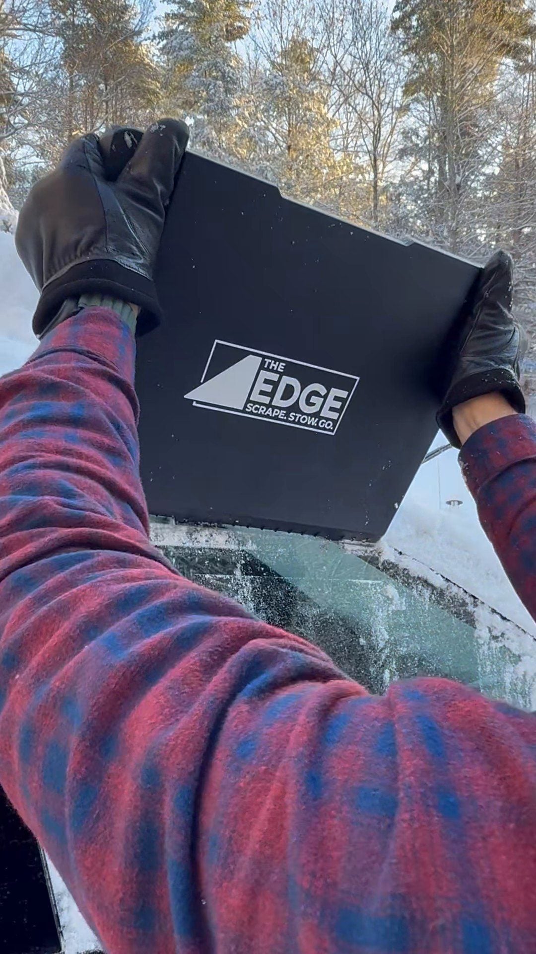 Clearing ice from a side window with The EDGE held overhead