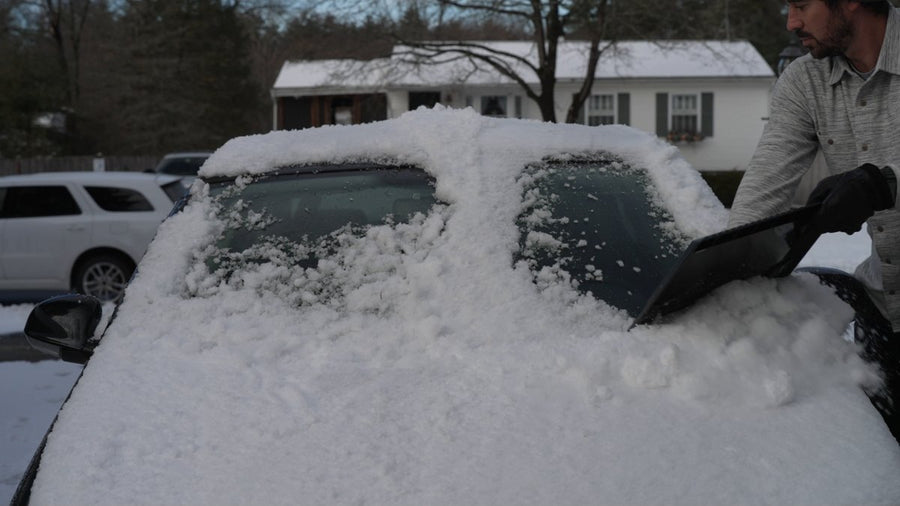 Rubber plow edge pushing snow off a car windshield