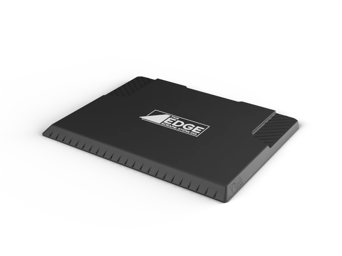 The EDGE snow and ice scraper: an 18 by 14 inch matte black tray with a rubber edge
